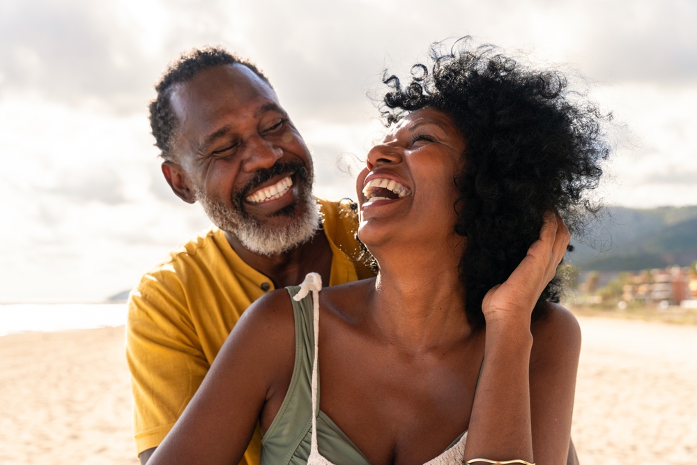 Happy retired couple on the beach